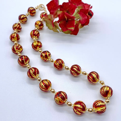 Necklace with red appliqué over gold Murano glass sphere beads on gold beads and clasp