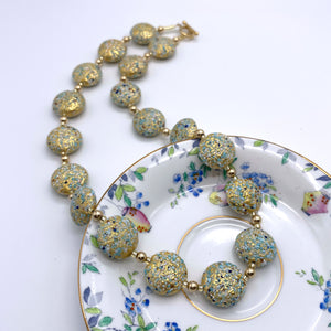 Necklace with speckled blues and white over gold Murano glass lentil beads on gold
