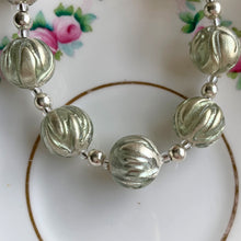 Necklace with grey appliqué over white gold Murano glass sphere beads on silver