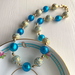 Necklace with speckled blues over gold and turquoise Murano glass sphere beads on gold
