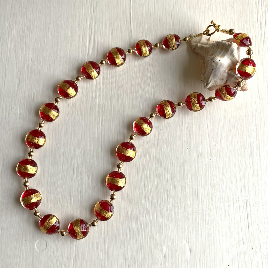 Necklace with red translucent and gold Murano glass medium lentil beads on gold