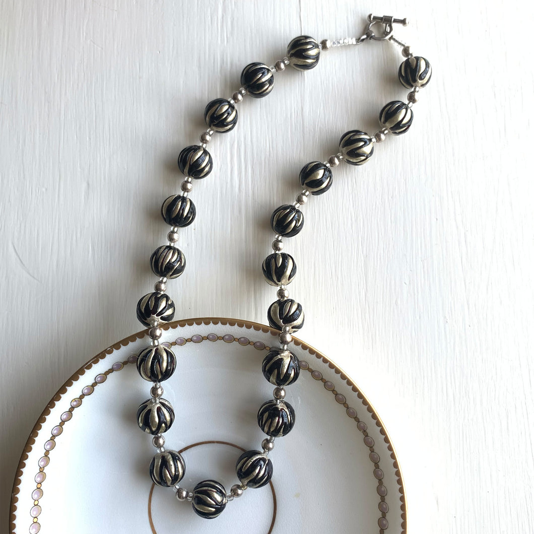 Necklace with black appliqué over white gold Murano glass sphere beads on silver