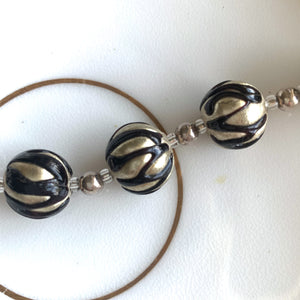 Necklace with black appliqué over white gold Murano glass sphere beads on silver