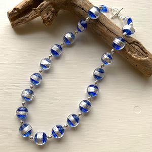 Necklace with blue translucent and silver Murano glass medium lentil beads on silver