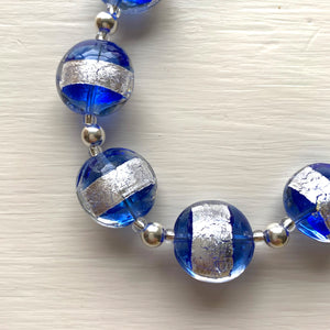 Necklace with blue translucent and silver Murano glass small lentil beads on silver