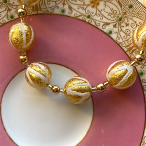 Necklace with white pastel drizzle and gold Murano glass sphere beads on gold