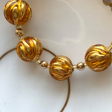 Necklace with gold topaz appliqué over gold Murano glass sphere beads on gold