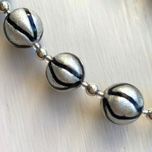 Necklace with black pastel drizzle and white gold Murano glass sphere beads on silver