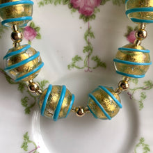Necklace with turquoise (blue) pastel appliqué spiral over gold Murano glass sphere beads on gold