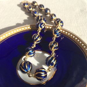 Necklace with dark blue (cobalt) appliqué over gold Murano glass sphere beads on gold