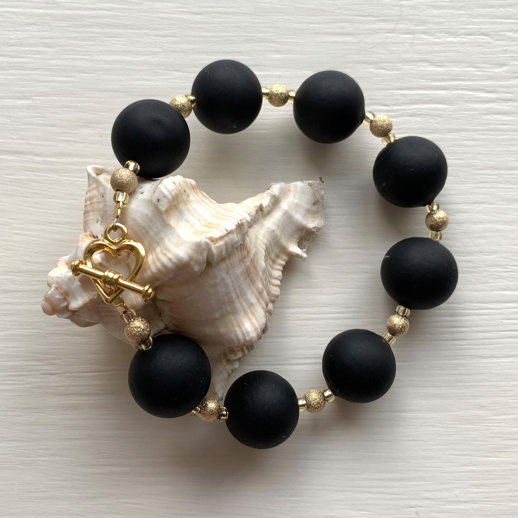 Bracelet with matt black Murano glass small sphere beads on gold stardust beads and clasp