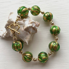 Bracelet with green appliqué over gold Murano glass small sphere beads on gold